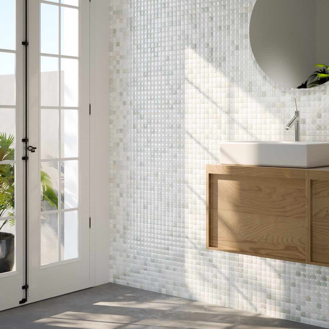 Modern bathroom with wooden vanity, white tiles, and a glass door.