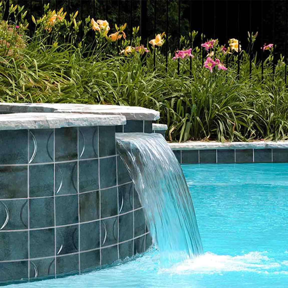 Patina Blu 4''x4'' Glossy Porcelain Tile installed on a waterfall and pool waterline