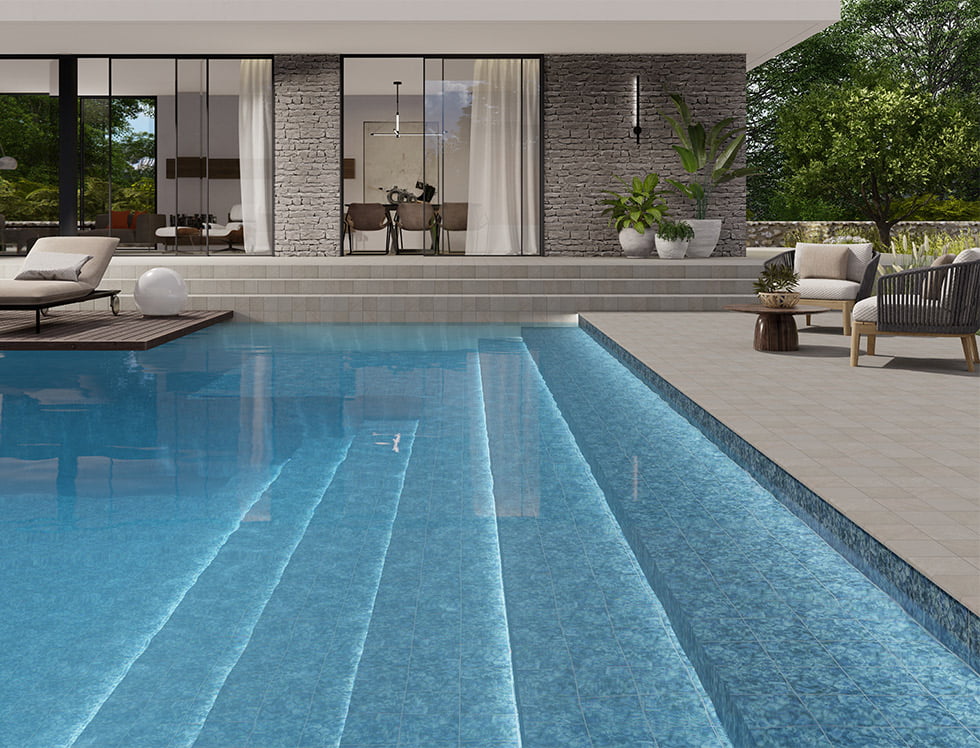 6x6 porcelain pool tile in Atol Marino shade, installed in a swimming pool to deliver a deep ocean blue look with vibrant water reflections and a serene, luxurious finish