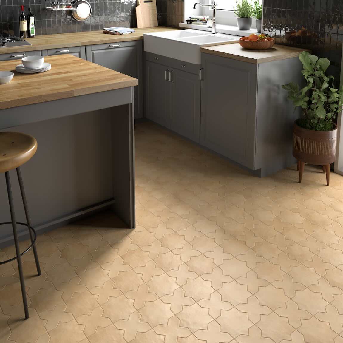 Modern kitchen with kasbah-patterned tile flooring, in color sand, wooden countertops, and gray cabinets.