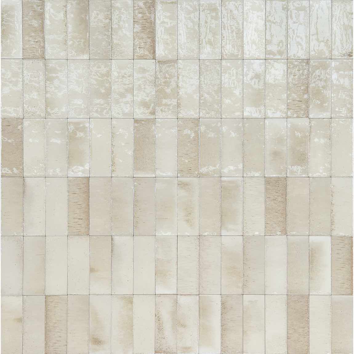 Wall covered in vertical, Storie Distressed Subway Tile Beige, with a pearlescent, textured finish in off-white and beige.