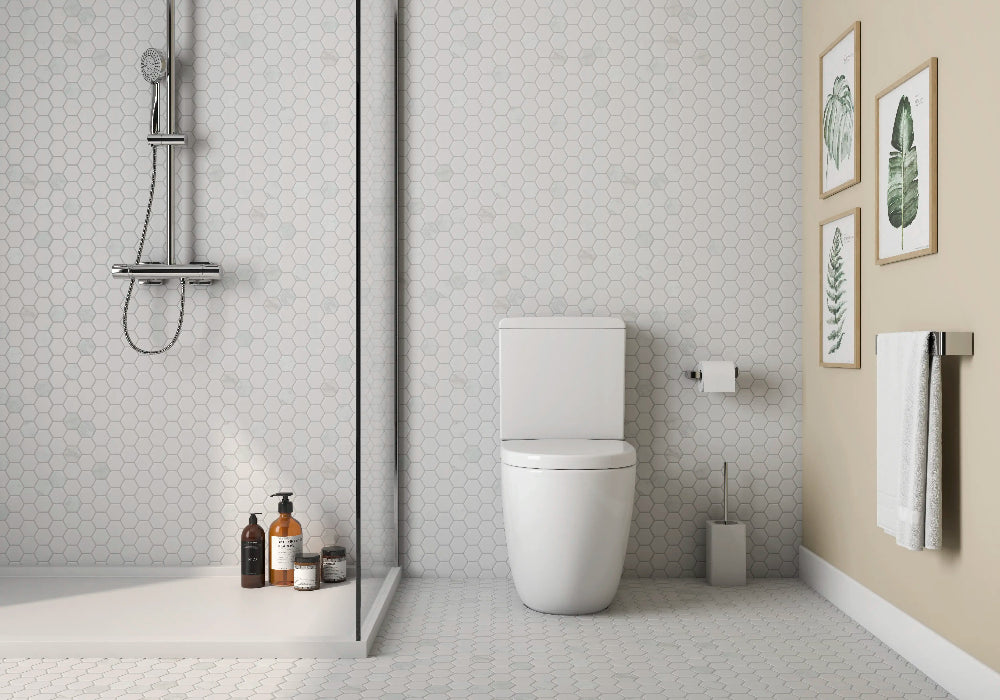Carrara white hexagon mosaic tile installed on a shower wall, showcasing a classic marble-inspired look with soft veining and a timeless, spa-like elegance