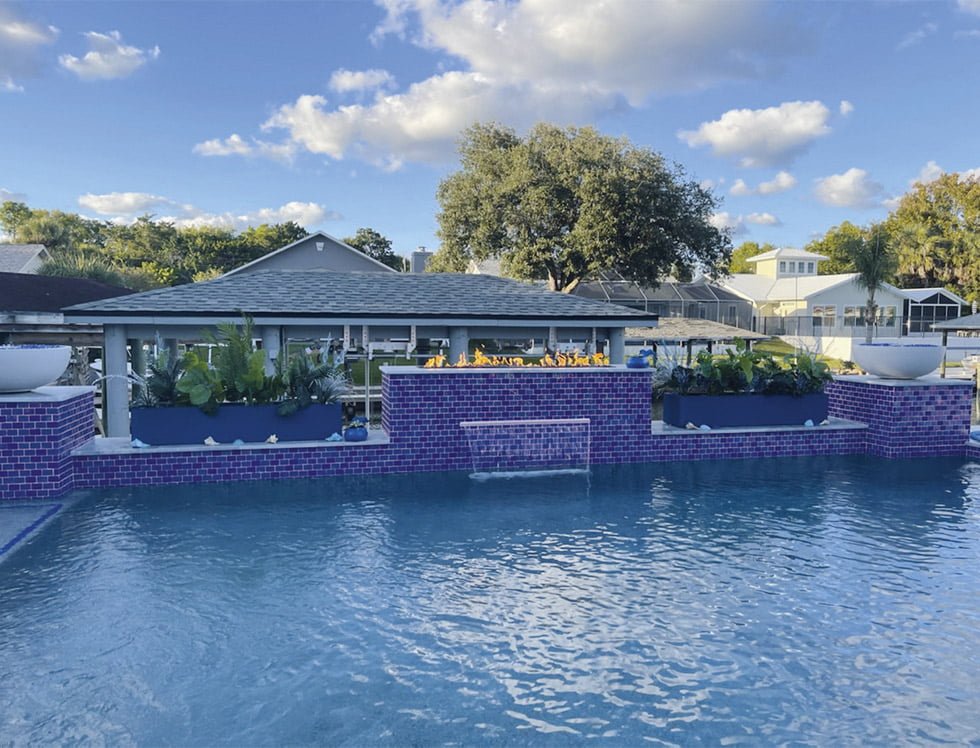 Iridescent glass tile in SoCal Cobalt Blue, sized 2x3, installed in a pool to create a brilliant, light-reflective surface with deep cobalt tones and a shimmering aquatic effect.