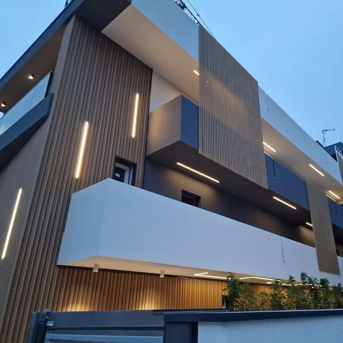 The Eco Slatted Wall Panel Rhythm Oak 8x96 featured on a building facade