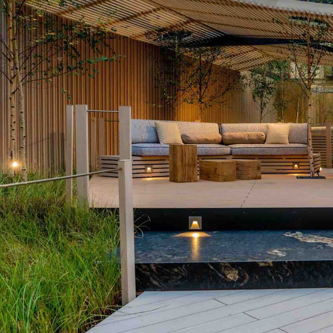 The Eco Slatted Decorative Wall Panel Rhythm Oak 8x96 featured on an outdoor featured wall