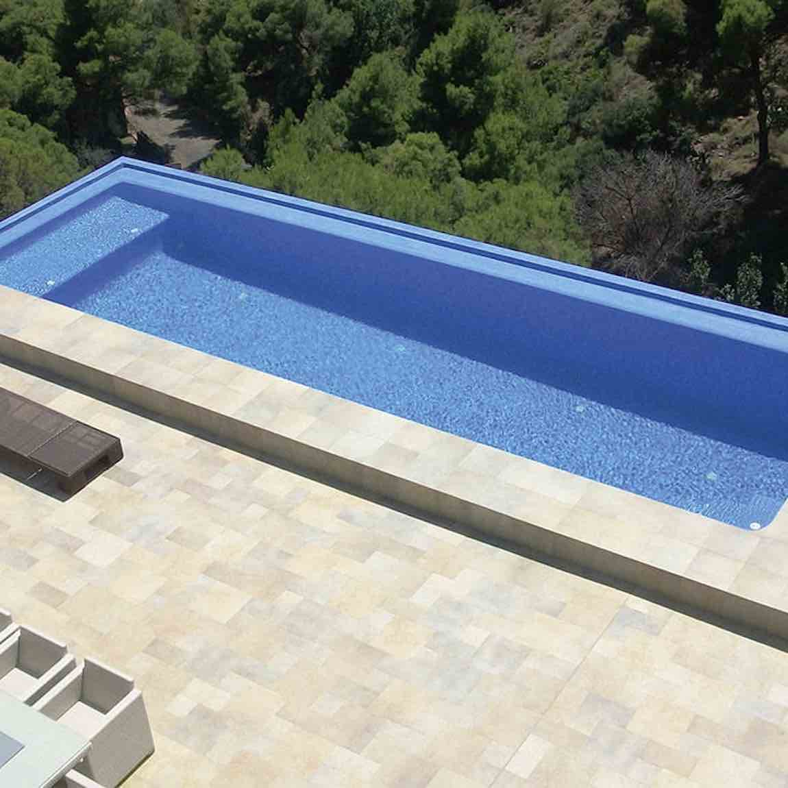 Recycled Glass Tile Light Blue for Pools and Spas featured on an infinity swimming pool