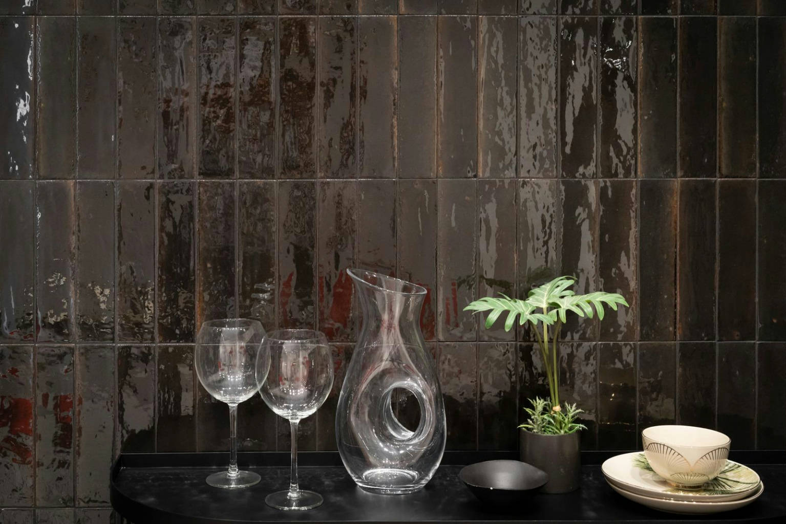 Distressed black subway tile installed on a bathroom floor, creating a bold, modern look with a touch of rustic elegance