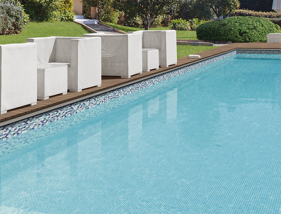 Iridescent glass tile blend installed in a swimming pool, reflecting sunlight to create a shimmering, colorful effect that adds depth and elegance to the water's surface