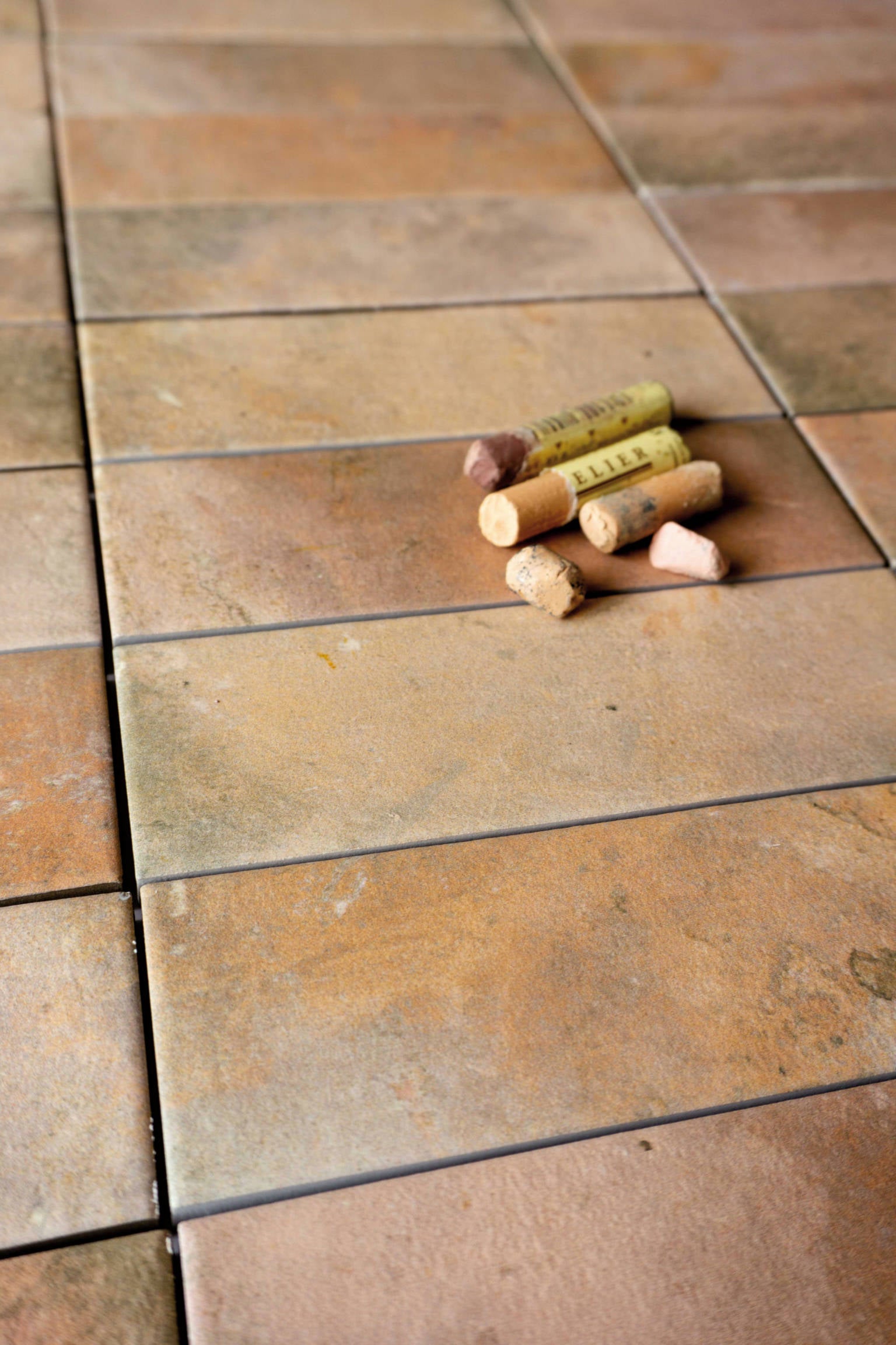 Dark terracotta porcelain tiles installed on an entrance floor, offering a warm, rustic welcome with natural earthy tones