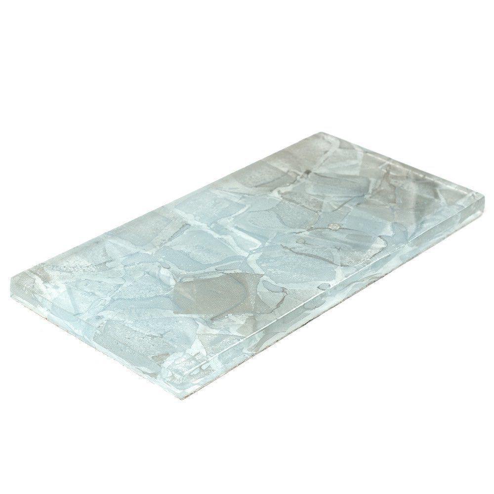 Angled shot of a single 3x6 Liquid Glass Subway Tile in Aqua, showcasing its textured surface.