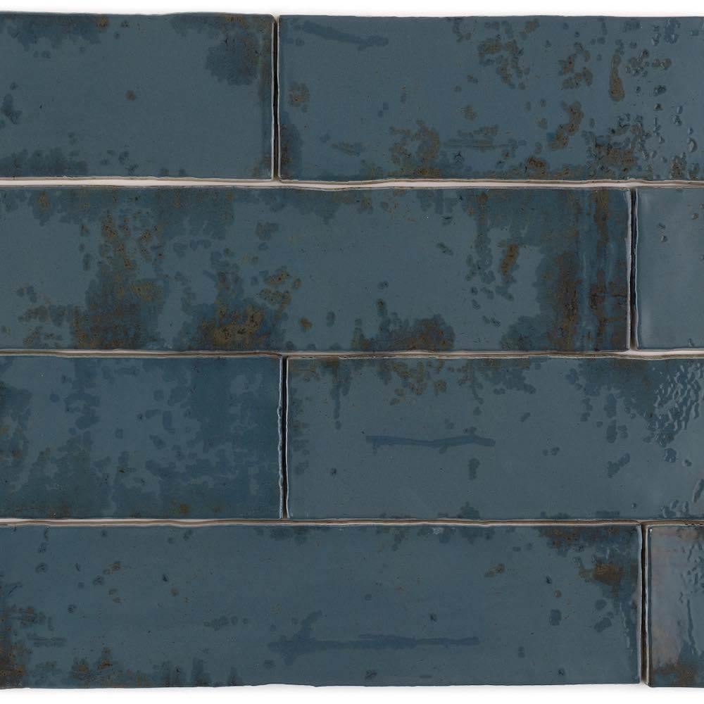 Stacked pattern of textured 3x12 Vintage Subway Tile in a deep blue color with varied tones.
