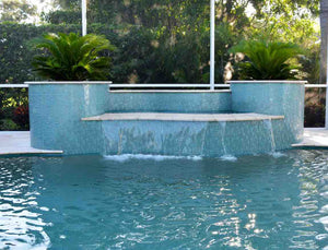 Iridescent Clear Glass Pool Tile Aqua Mixed installed on a pool waterfall