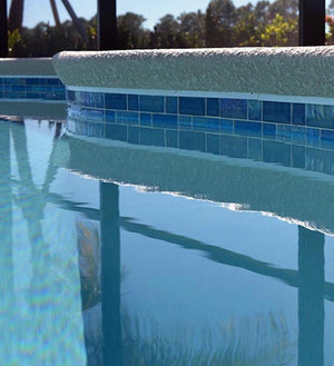 Swimming pool waterline using iridescent glass tiles