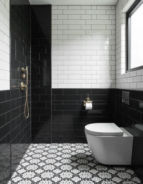 Modern black and white bathroom featuring white subway tiles, black accent wall, and hexagonal floor tiles.