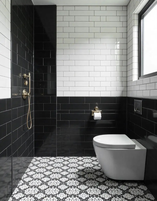 Modern black and white bathroom featuring white subway tiles, black accent wall, and hexagonal floor tiles.