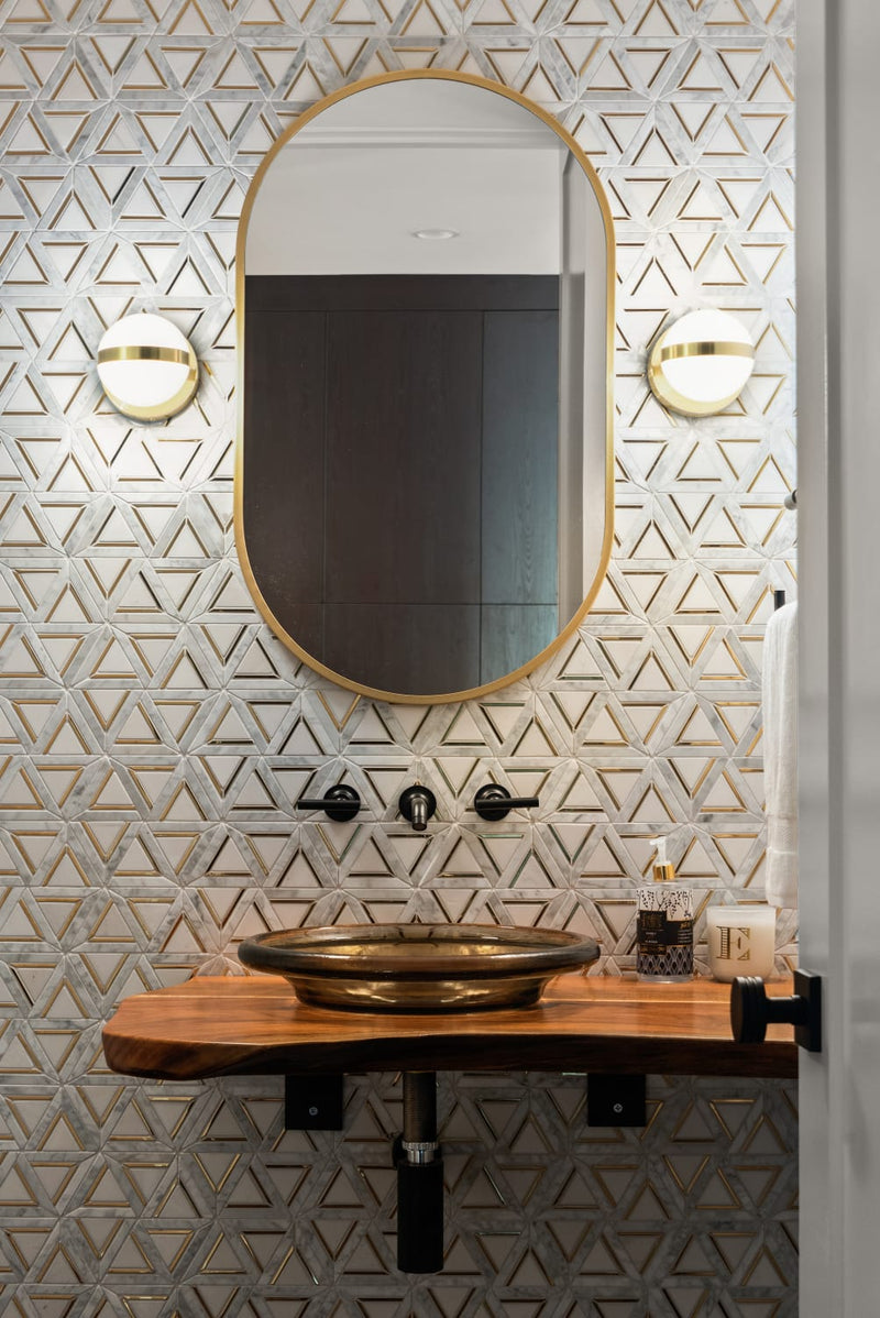 Luxurious bathroom featuring brass gold and white marble mosaic tile by Mineral Tiles