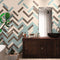 Different Colors Subway Tile Herringbone Pattern on a Bathroom Wall