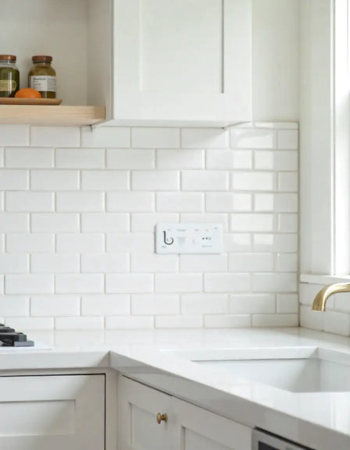 Bullnose tile edge finishing a white subway tile backsplash, showing the smooth, clean transition.