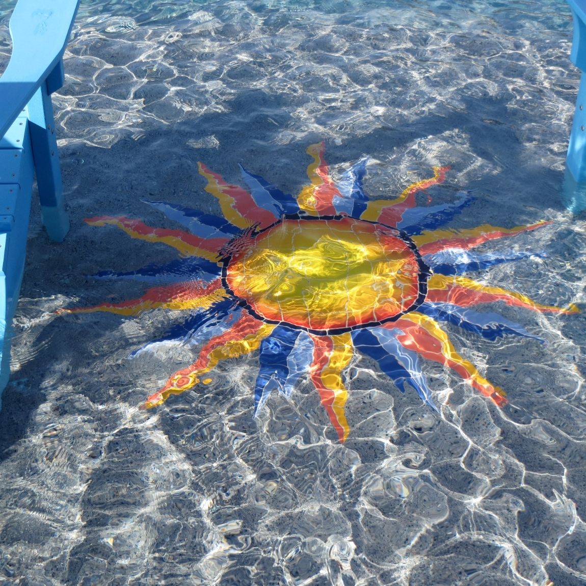 Porcelain Sun Medallion Orange Mosaic installed on a pool entrance.