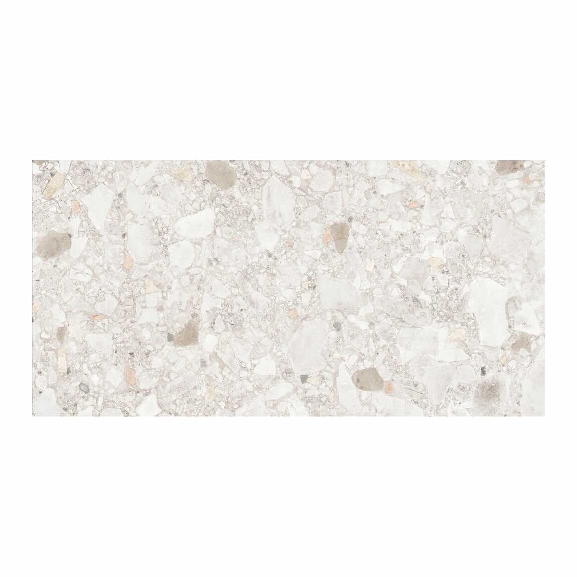 Close-up of a textured white surface with small gray and beige stones.
