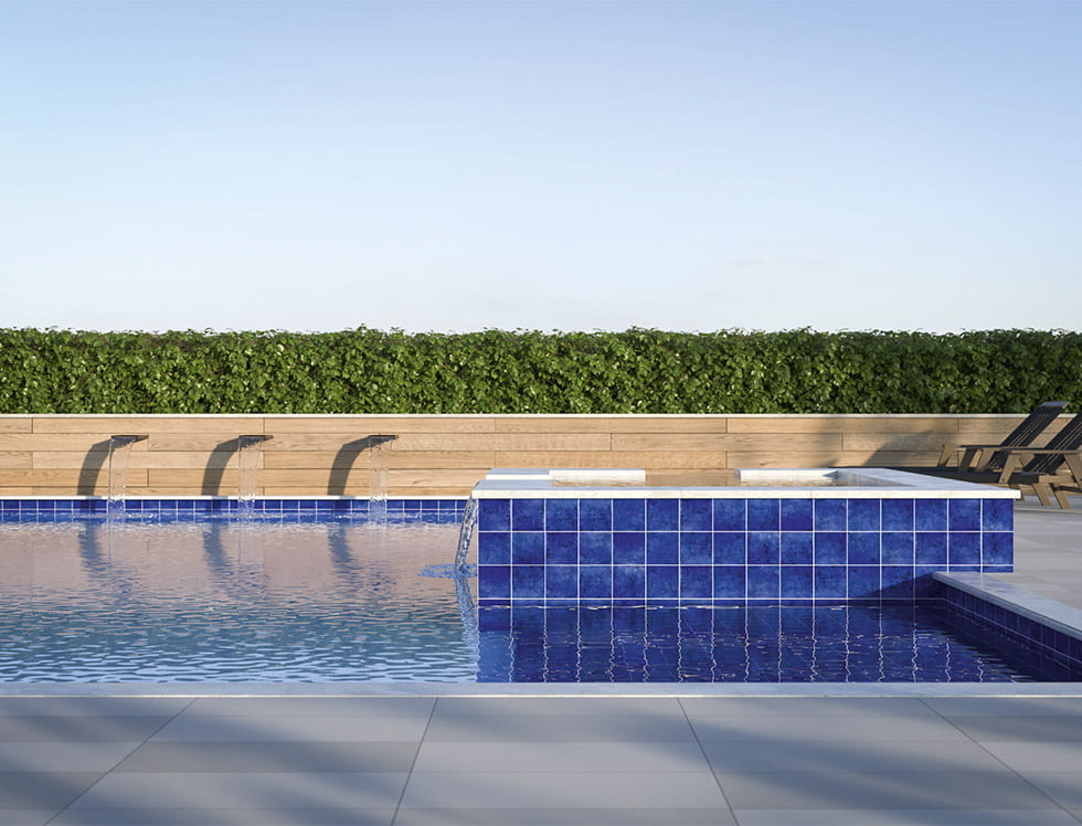 Classic cobalt blue porcelain pool tile installed in a swimming pool, adding a bold, vibrant, and sophisticated look to the water with deep, rich tones