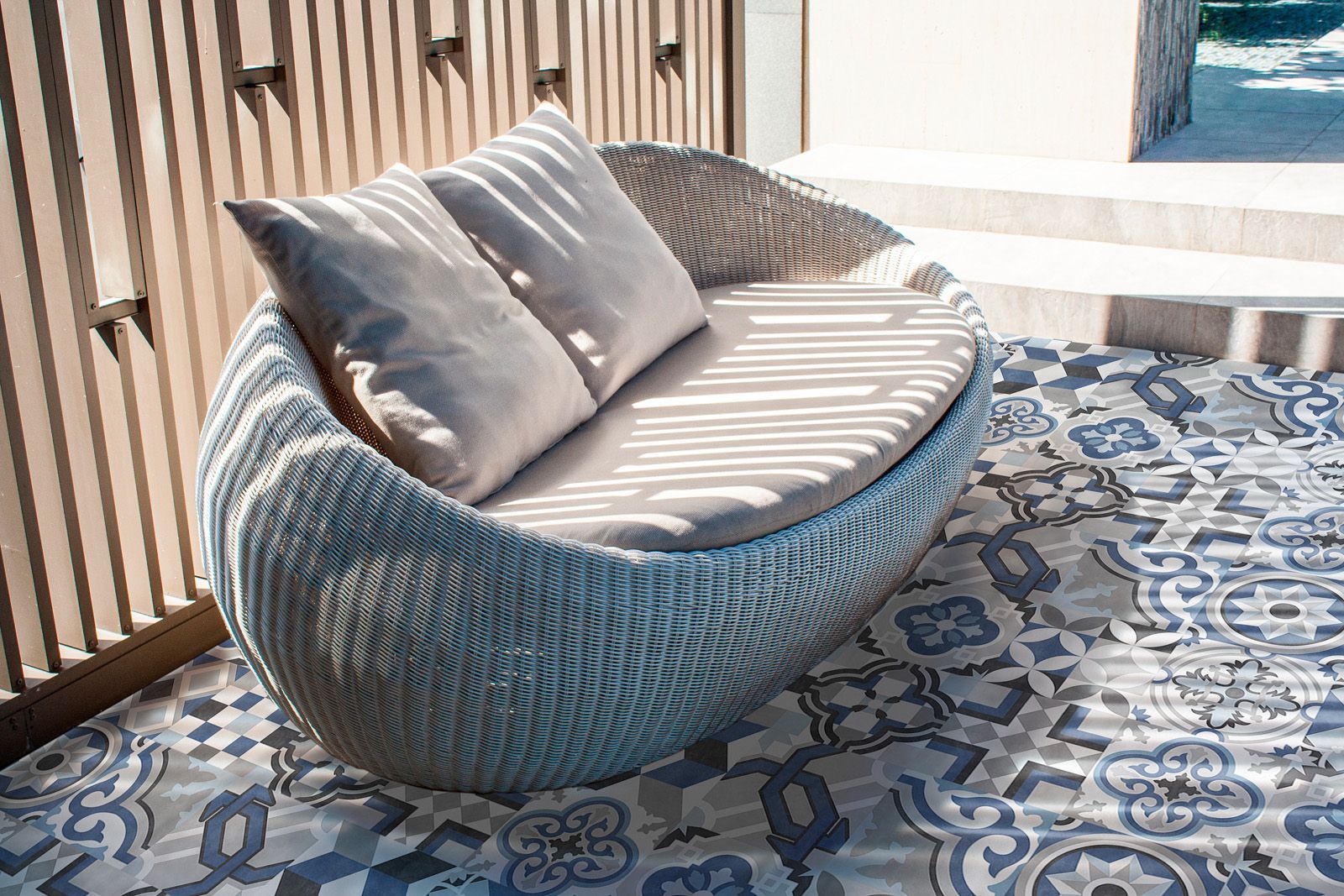 Blue geometric patterned porcelain tile installed on a patio floor, creating a vibrant and stylish outdoor space with a modern design flair