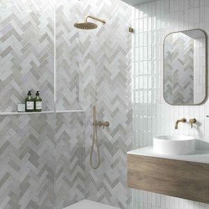 Petite Ville Subway Porcelain Tile Gray 2x6 in a herringbone pattern on a shower wall