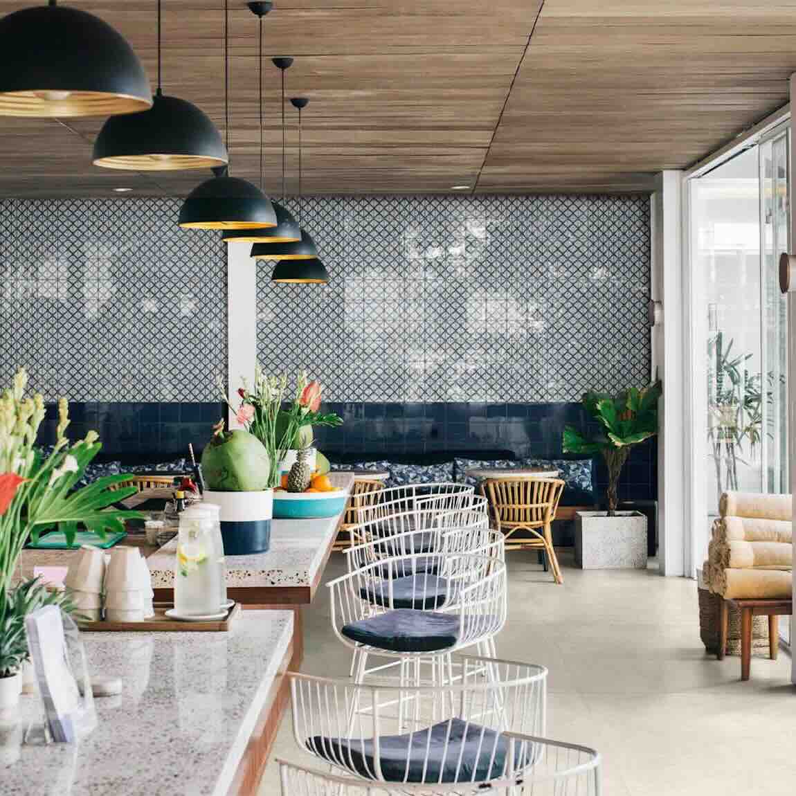 Modern Mediterranean restaurant featuring blue patterned tiles by Mineral Tiles