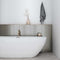 Picket Tile Arrow Silver 2x10 featured on a bathroom wall behind a contemporary tub