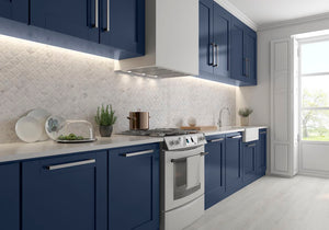 Lantern Carrara Mosaic Tile Honed featured on a contemporary kitchen backsplash with blue cabinets and white quartz countertop