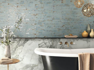 Vintage Distressed Picket Tile Rust 2x10 installed on a bathroom wall behind a classic bathtub