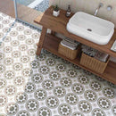 Patterned Porcelain Tile Herb 8x8 features on a bathroom floor with wood furniture