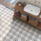 Patterned Porcelain Tile Herb 8x8 features on a bathroom floor with wood furniture