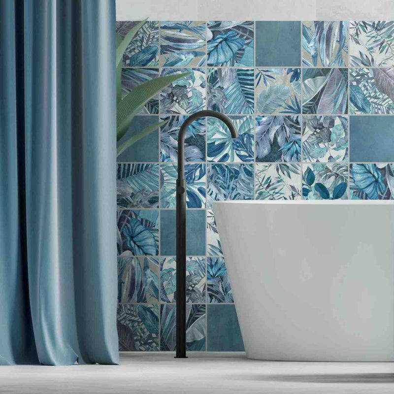 bathroom featured wall with floral patterned tiles behind free standing bathtub