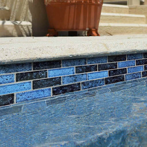 Dark Pool Glass Mosaic Tile Blue 1x3 installed on a pool waterline
