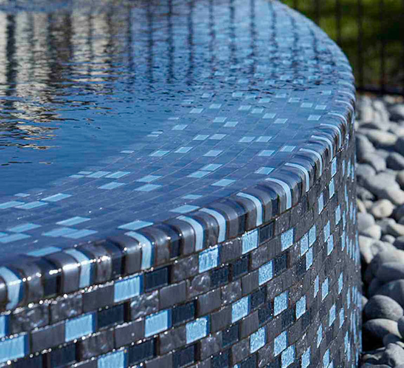 Glass Pool Mosaic Tile Blue Blend 1x2 installed on a infinity pool wall