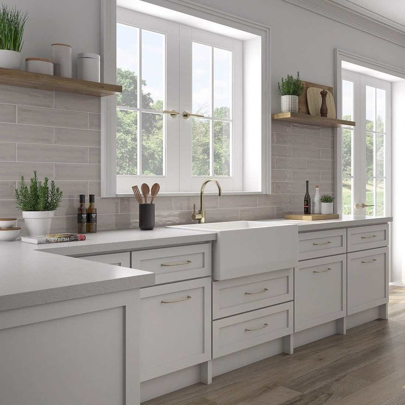 Kitchen backsplash with white cabinets and quartz featuring a gray subway tile by Mineral Tiles