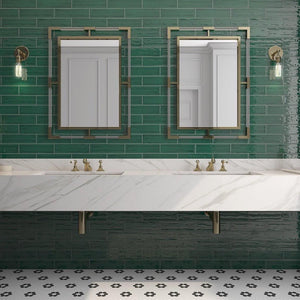 bathroom with green subway tile and calacatta gold marble countertop