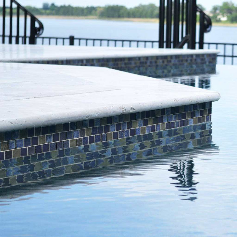 Pool waterline using a dark blue and charcoal glass mosaic tile
