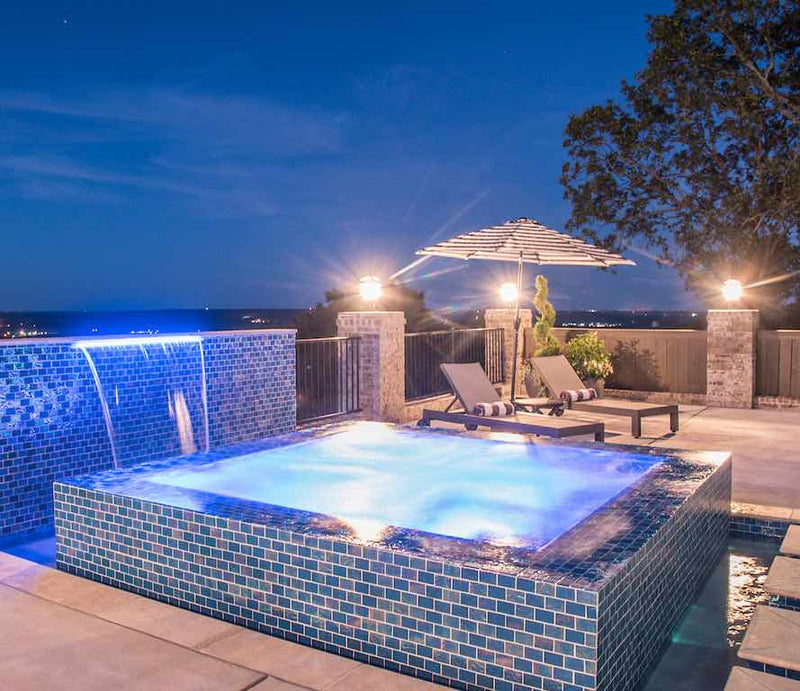 rooftop pool and waterfall in a residence made with all iridescent glass tiles turquoise by Mineral Tiles