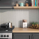 Herringbone Mosaic Tile Vintage Pearl White installed on a kitchen backsplash