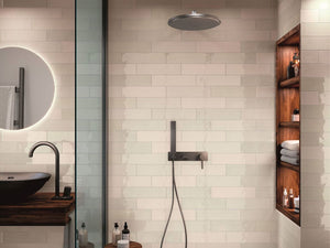 contemporary shower design idea featuring a glossy subway tile