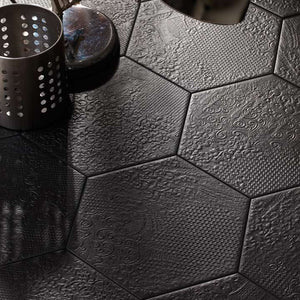 Studio Hexagon Texturized Black Porcelain Tile 9x10 installed on a floor