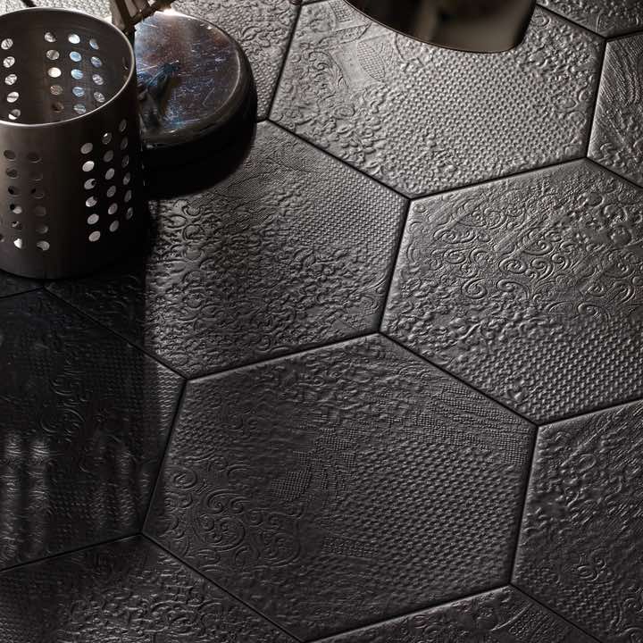 Studio Hexagon Texturized Black Porcelain Tile 9x10 installed on a floor