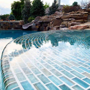 Tanning edge pool made with turquoise glass tiles by Mineral Tiles